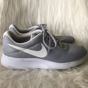 A pair of grey Nike Tanjun shoes